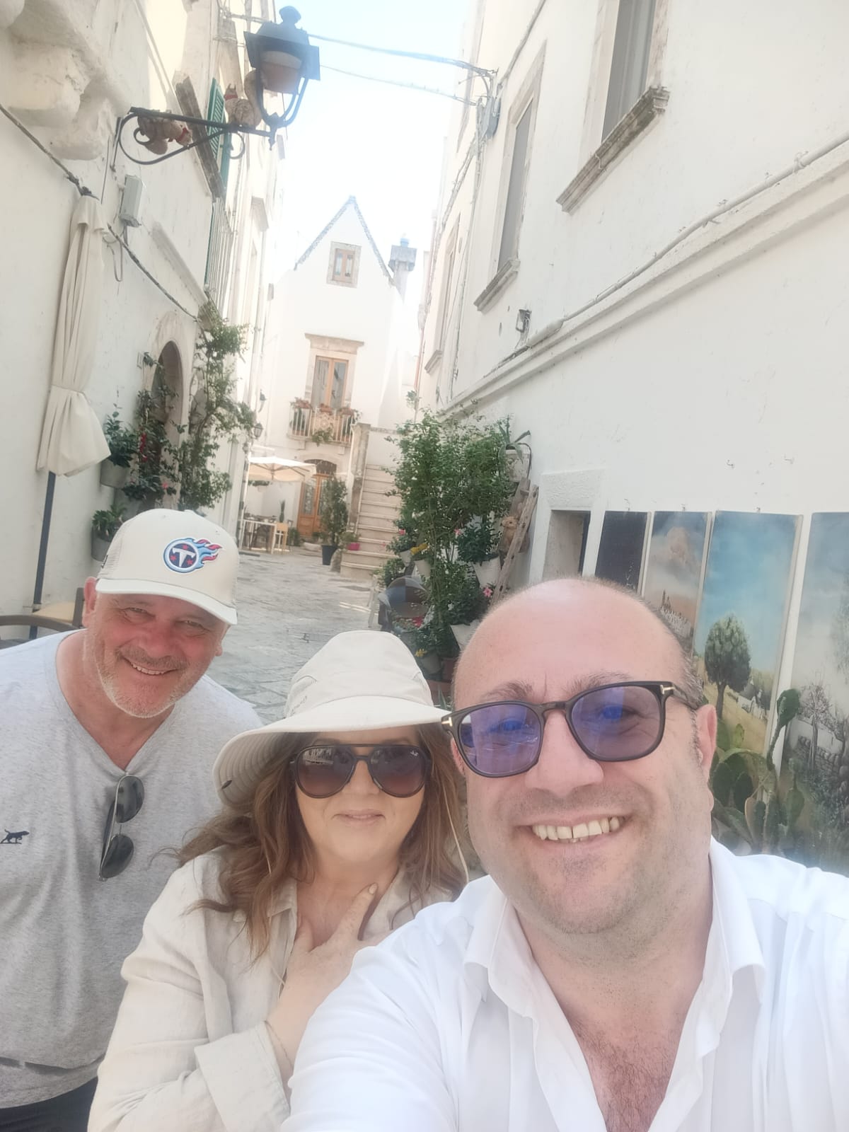 Lorenzo Cappiello with a couple of travellers in a village with whitewashed streets