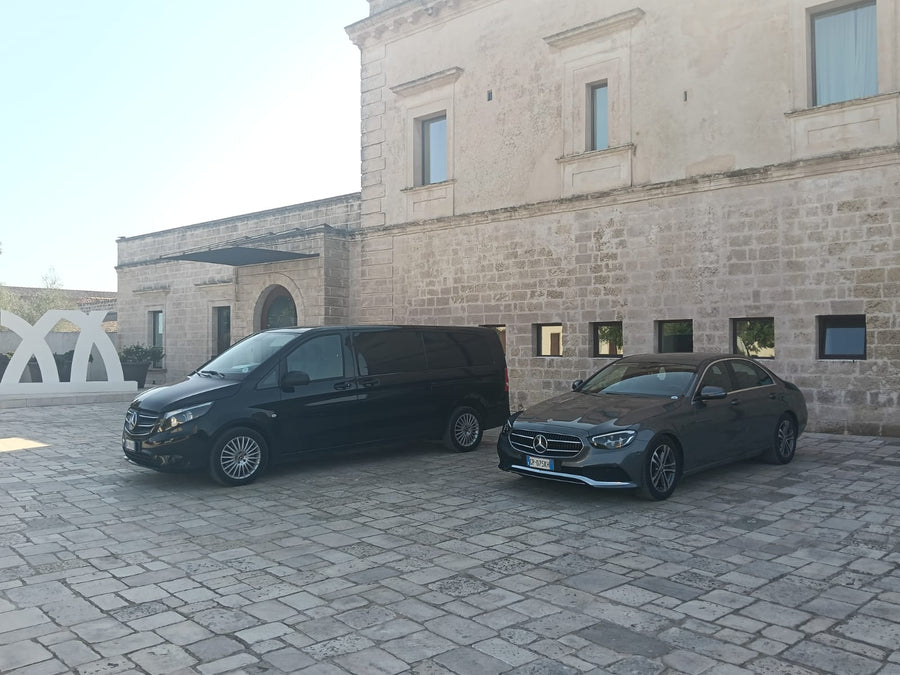 PugliaCab minivan and car in a stone courtyard
